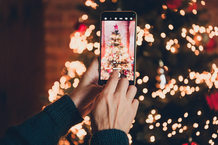 Cropped photo of nice senior female take photo tree wear christmas clothes enjoy cozy x-mas party decoration interior flat indoorsの写真素材