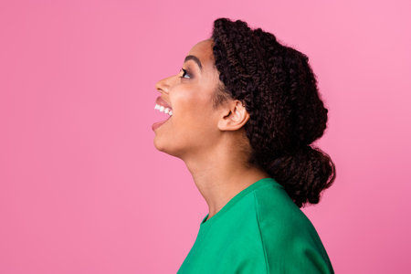 Photo portrait of pretty young girl profile excited reaction scream wear trendy green outfit isolated on pink color backgroundの写真素材