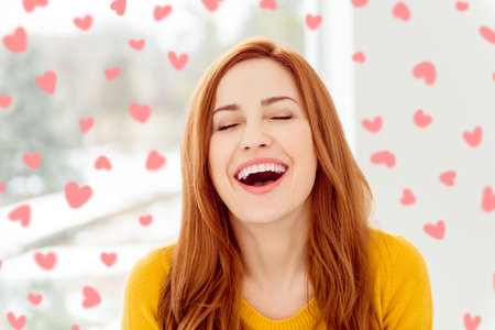 Close up photo of beautiful, attractive, pretty, cute, sweet, gorgeous, nice lady close eyes throw back head and make toothy smile spend free time on couch in yellow pullover in modern light interiorの写真素材