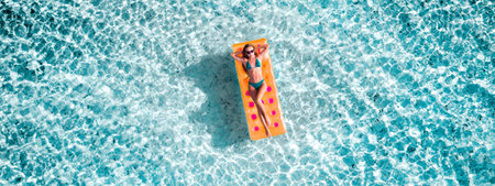 Top above high angle aerial drone view of fit slim thin slender girl floating on rubber mattress...