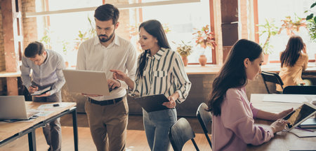 Focused leader coach collar man woman work laptop clipboard have conference decide document start up...