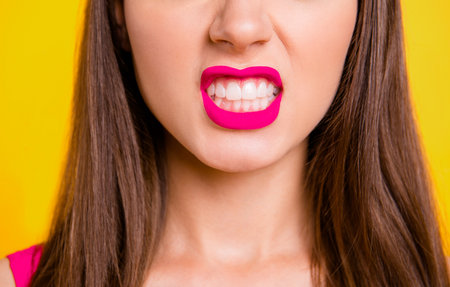 Cropped close up view photo portrait of pretty beautiful lady demonstrating white teeth isolated on bright backgroundの写真素材