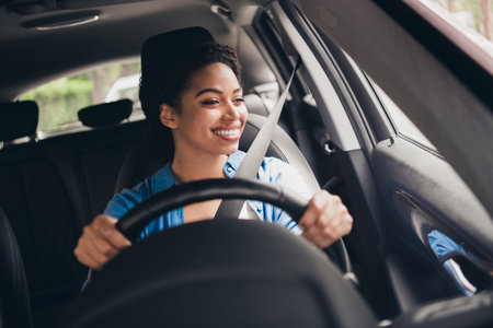 Young African American woman enjoying a drive in the city in daylightの写真素材