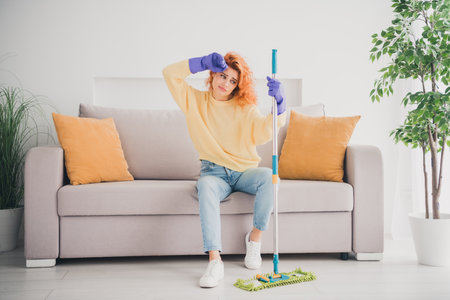 Photo of pretty upset lady wear yellow pullover feeling tired housekeeping indoors room home house