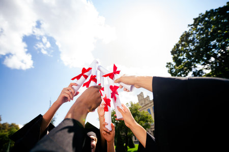 First person view photo of groupmates raise diploma sky students mortarboard gown graduate college...