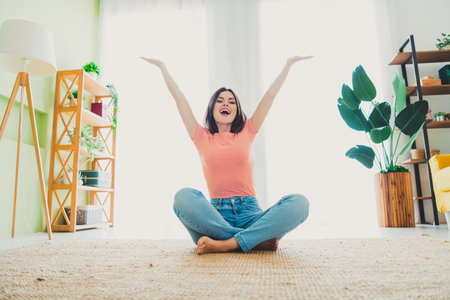 Young woman in casual outfit enjoying a relaxed weekend in her stylish and comfortable living room