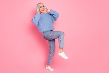 Full body photo of lovely pensioner lady listen music dance headphones dressed stylish blue knitwear...
