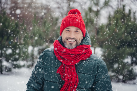 Photo of funny handsome middle age guy wear windbreaker smiling walking snowy weather outside urban...