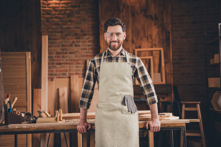 Photo of workman in protective clothes stand in garage homeの写真素材