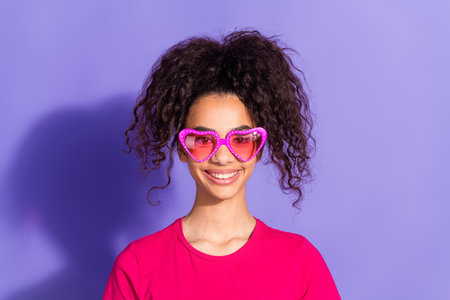 Photo of charming positive woman wear pink top sunglass smiling empty space isolated violet color...