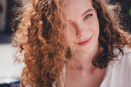 Photo of pretty sweet woman look camera dreamy smile dressed white shirt outdoors urban modern townの写真素材