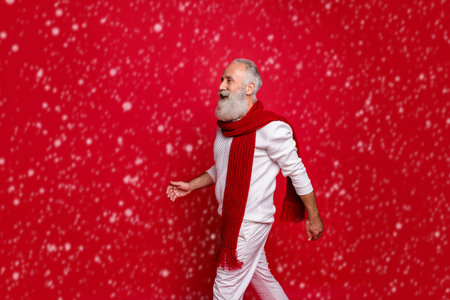 Profile side view of his he nice attractive well-dressed gray-haired man walking going motion movement coming December isolated over bright vivid shine red backgroundの写真素材
