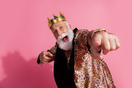 Photo of cool old man excited point camera you wear glamour leopard print outfit isolated pink color backgroundの写真素材