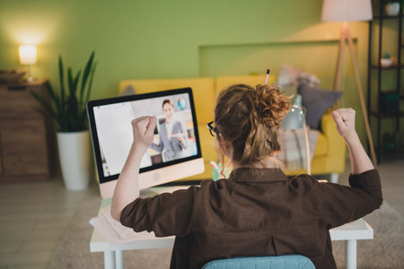 Back view photo of charming cheerful happy woman wear shirt distance education studying from home indoorsの写真素材