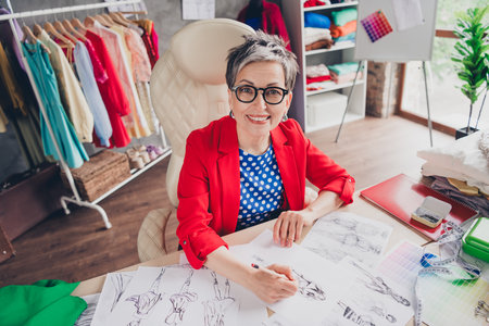 High angle view photo of aged clothing designer lady hold paper drawing loft interior office studio indoorsの写真素材