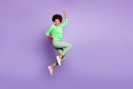 Full body photo of delighted afro american girl celebrate autumn spring jackpot victory raise fists...