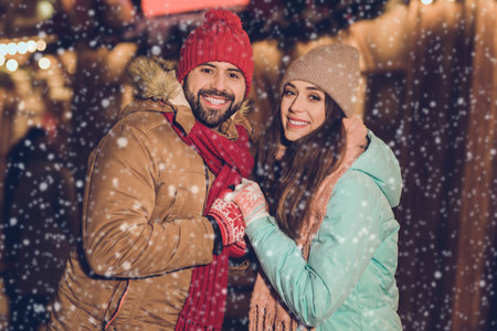 Photo of adorable charming wife husband walking holding arms together smiling outside city fair streetの写真素材