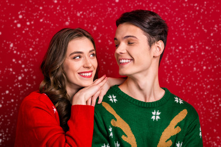 Photo of cheerful wife husband hands shoulders look each other enjoy magic time season anniversary day isolated on red color backgroundの写真素材