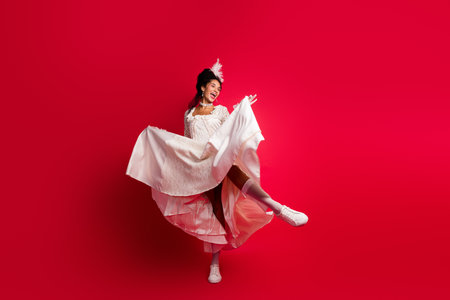 Photo of lady actress princess in antique style dress dancing moving isolated red color backgroundの写真素材