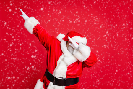 Portrait of his he nice attractive careless bearded Santa having fun leisure fairy eve noel fest celebratory wintertime isolated over bright vivid shine red backgroundの写真素材