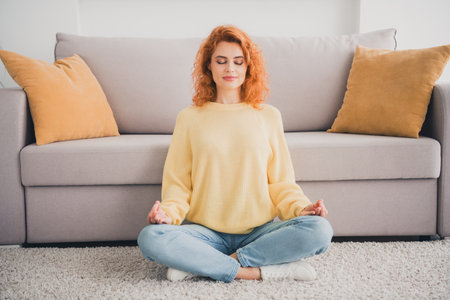 Photo of pretty cheerful lady wear yellow pullover smiling enjoying yoga indoors room home houseの写真素材