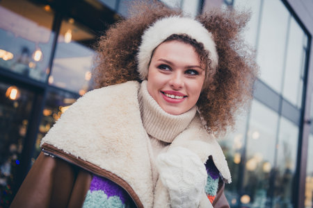 Photo of pretty young woman look away contemplate wear jacket walk snowy street weekend outdoorsの写真素材