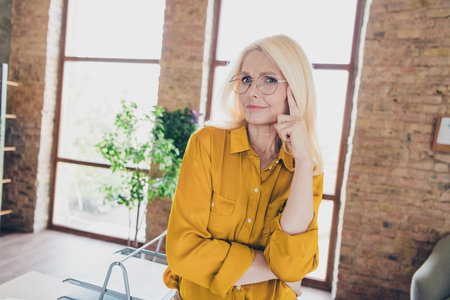 Photo of unsure uncertain lady broker wear shirt finger temple looking you indoors workplace workshopの写真素材