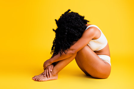 Studio no retouch photo of sensual dreamy lady dressed lingerie enjoying girls power blank space isolated yellow color backgroundの写真素材