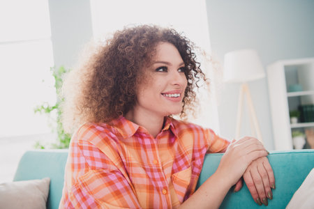 Charming Young Woman Relaxing Indoors and Enjoying a Casual Day at Homeの写真素材