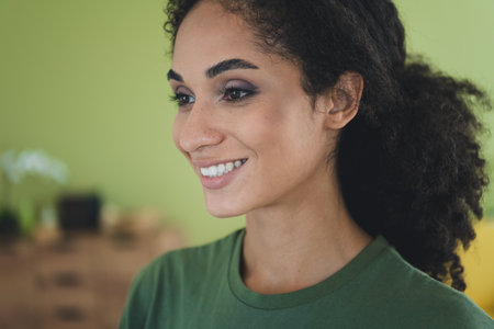Photo of lovely young girl cheerful smile charming dressed green garment house home indoors roomの写真素材