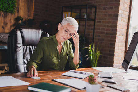 Photo of sad attractive lady wear shirt drink pills suffer migraine workplace workstation loft interior indoorsの写真素材