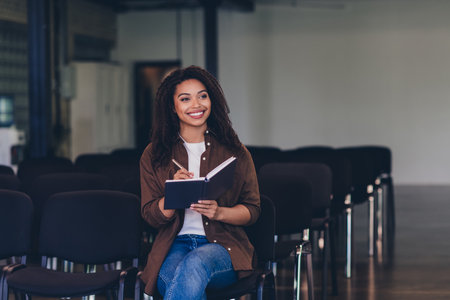 Photo of young ambitious lady listen workshop write notepad conference room business center indoorsの写真素材