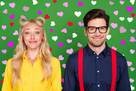 Photo of young vintage couple event discotheque glamour vintage partners isolated over green color backgroundの写真素材