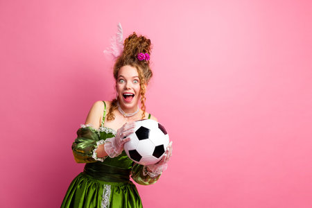 Eccentric combination of modern sports with elegant historical costume on pink backgroundの写真素材