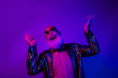 Photo of cheerful positive guy dressed shiny costume star eyeglasses enjoy glamour event emtpy space isolated purple color backgroundの写真素材