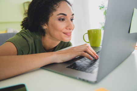 Photo of lovely young girl excited work netbook dressed green garment house freelancer home office...