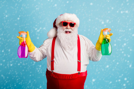 Portrait of his he nice attractive cheerful cheery glad overweight Santa cleaning up holding in hands supplies isolated bright vivid shine vibrant blue color backgroundの写真素材