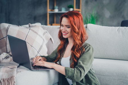 Photo of adorable sweet lady wear khaki shirt sending emails modern device indoors room home house