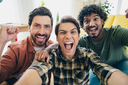 Portrait of three best friends take selfie raise fists gather chill free time modern interior flat...