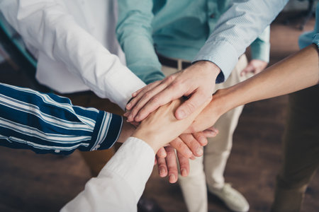 Cropped photo of teamwork startup partners hold hands support comfortable nice creative startup...
