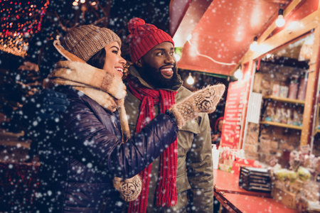 Photo of funny pretty husband wife wear winter season clothes buying xmas presents outsite urban city streetの写真素材