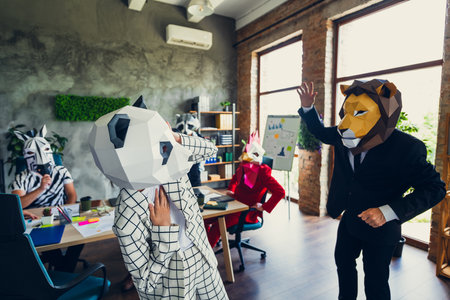 Portrait of panda rooster gorilla lion sloth zebra raccoon mask business people communicate loft business center indoorsの写真素材