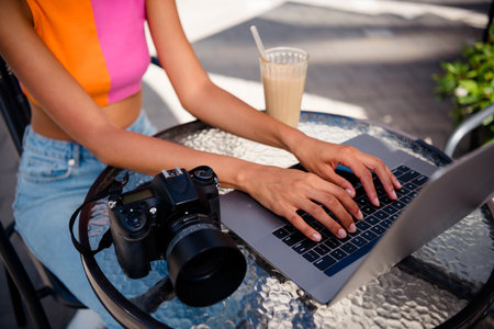 Cropped photo of girl edit photos sit cafe table photographer wear colorful outfit walk park sunlight spring weather travel weekend outsideの写真素材