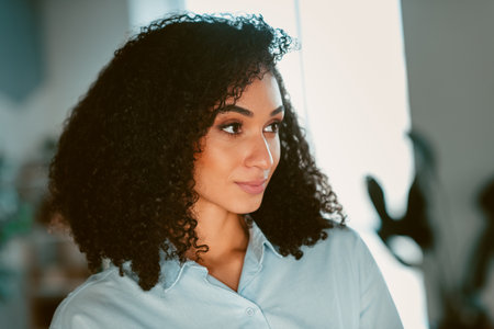 Portrait of a young woman indoors wearing casual clothing, showcasing natural beauty and style in a relaxed and comfortable ambianceの写真素材