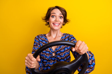 Photo of young cheerful beginner driver holding steering wheel control automobile with satisfaction...