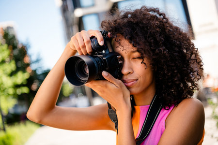 Photo of pretty young woman street photographer wear colorful clothes walk outside urban recreation city parkの写真素材