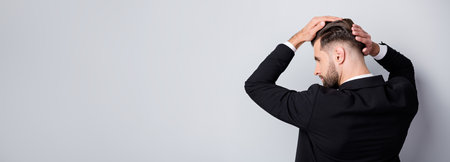 Back rear profile side photo of serious handsome worker man touch silky hair after haircare barber shop treatment partnership meeting wear black blazer isolated grey color backgroundの写真素材