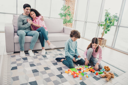 Happy family spending quality time together at home in a cozy living room, capturing joyful memories...