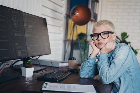 Professional young woman working while programming tasks at home officeの写真素材