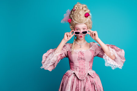 Portrait of medieval princess girl stare empty space wear luxury dress isolated on turquoise color backgroundの写真素材